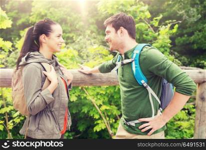 travel, hiking, backpacking, tourism and people concept - smiling couple with backpacks in nature. smiling couple with backpacks in nature. smiling couple with backpacks in nature