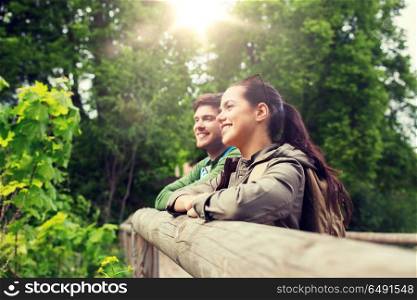 travel, hiking, backpacking, tourism and people concept - smiling couple with backpacks in nature. smiling couple with backpacks in nature. smiling couple with backpacks in nature
