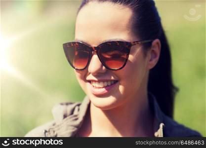 travel, hiking, tourism, eyewear and people concept - face of happy young woman in sunglasses outdoors. face of happy young woman in sunglasses outdoors. face of happy young woman in sunglasses outdoors