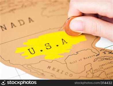 Travel holiday to United States of America concept with female hand scratching map choosing USA