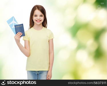 travel, holiday, vacation, childhood and transportation concept - smiling little girl with airplane ticket and passport