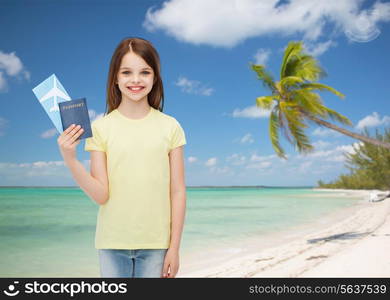 travel, holiday, vacation, childhood and transportation concept - smiling little girl with airplane ticket and passport