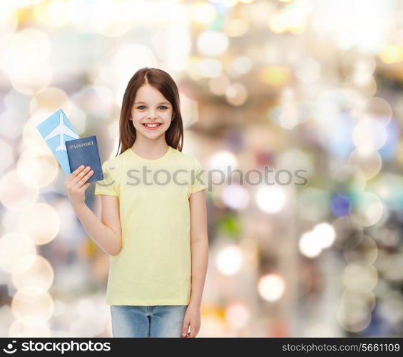 travel, holiday, vacation, childhood and transportation concept - smiling little girl with airplane ticket and passport