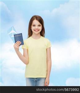 travel, holiday, vacation, childhood and transportation concept - smiling little girl with airplane ticket and passport