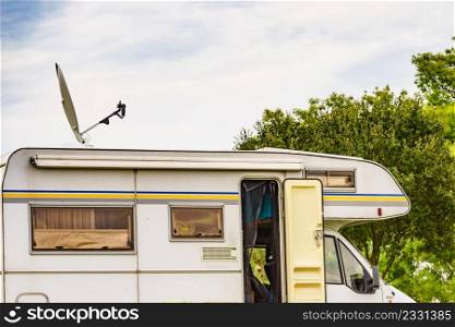Travel holidays in motorhome. Caravan with satellite dish on roof camping on green nature. .. Caravan with satellite dish on roof