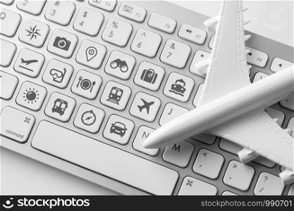 Travel icon on computer keyboard for online booking concept