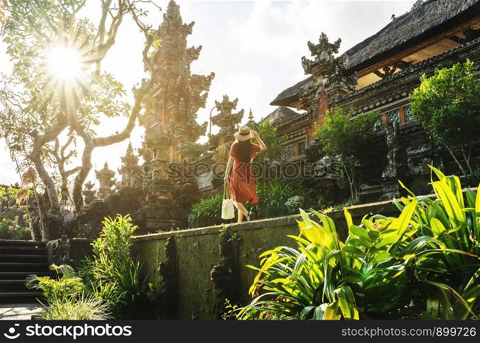 Travel in Bali, Image of woman tourist walking in Pura saraswati temple in Indonesia.