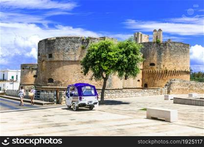 Travel in south of Italy. medieval town Otranto in Puglia region. Old castle in downtown and local transport motorbike taxi jul 2018