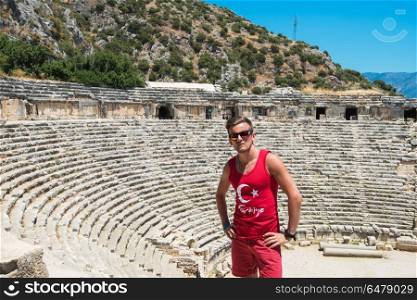Travel in turkey. Young man at theatre in Myra ancient city of Antalya in Turkey.