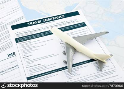 travel insurance form and plane model on world map paperwork, concept and idea for insurance business