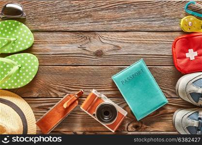 Travel items: beach vs. hike. Still life over wooden background.