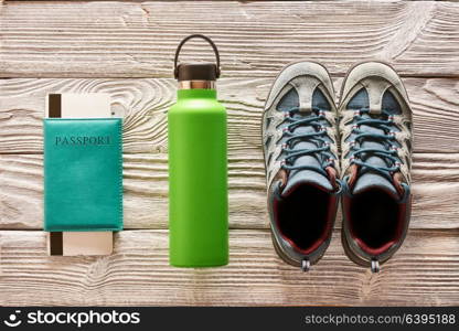 Travel items for hiking tourism flat lay still life over wooden background