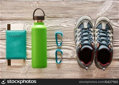 Travel items for hiking tourism flat lay still life over wooden background