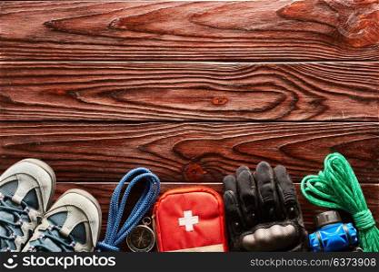 Travel items for hiking tourism still life over wooden background