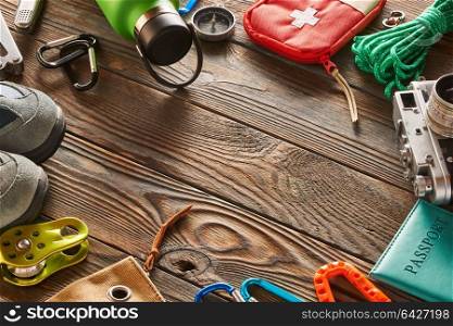 Travel items for hiking tourism still life over wooden background