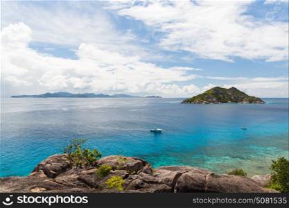 travel, landscape and nature concept - island and boats in indian ocean on seychelles. island and boats in indian ocean on seychelles