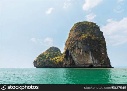 travel, landscape, tourism, summer holidays and nature concept - krabi island cliff in ocean water at thailand. krabi island cliff in ocean water at thailand