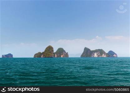 travel, landscape, tourism, summer holidays and nature concept - krabi island cliffs in ocean water at thailand. krabi island cliffs in ocean water at thailand