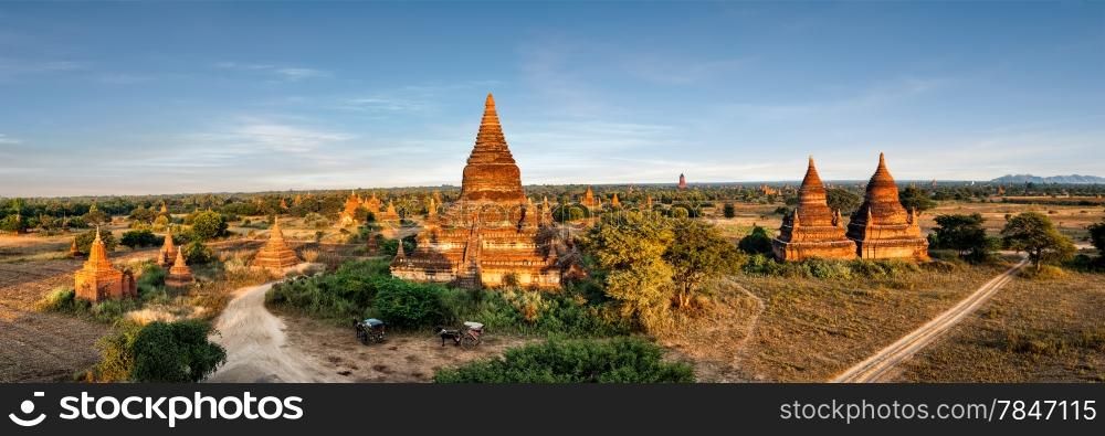 Travel landscapes and destinations panorama view. Tourists horse carriage in front of ancient Mahazedi Pagoda. Amazing architecture of old Buddhist Temples at Bagan Kingdom, Myanmar (Burma)