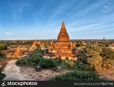 Travel landscapes and destinations. Tourists horse carriage in front of ancient Mahazedi Pagoda. Amazing architecture of old Buddhist Temples at Bagan Kingdom, Myanmar (Burma)