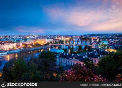 Travel Prague concept background - elevated view of bridges over Vltava river from Letna Park. Prague, Czech Republic in twilight. Panoramic view of Prague bridges over Vltava river