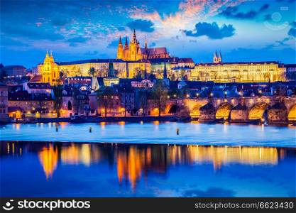 Travel Prague Europe background - view of Prague Castle and St. Vitus cathedral in twilight with dramatic sky. Prague, Czech Republic. Prague Castle in twilight