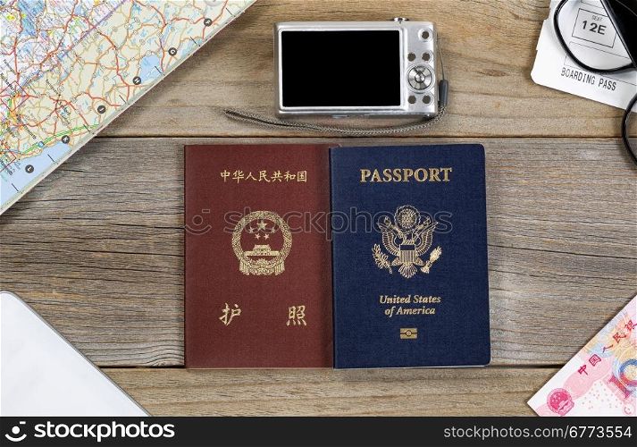 Travel preparations with passports, money, map, camera, cell phone, boarding pass and reading glasses.