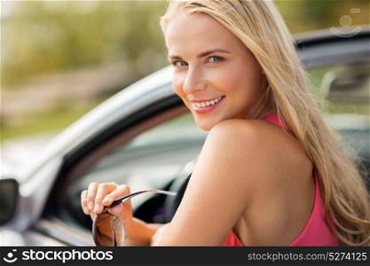 travel, road trip and people concept - close up of happy young woman in convertible car. happy young woman in convertible car
