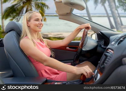 travel, road trip and people concept - happy young woman driving convertible car over tropical beach background in french polynesia. happy woman driving convertible car over beach