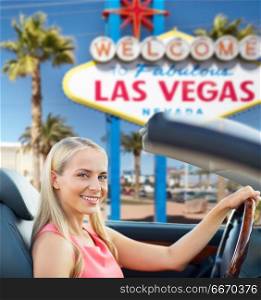 travel, road trip and people concept - happy young woman driving convertible car over welcome to fabulous las vegas sign background. woman driving convertible car over las vegas sign. woman driving convertible car over las vegas sign