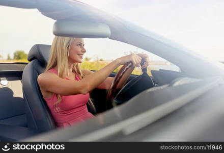 travel, road trip and people concept - happy young woman driving convertible car. happy young woman driving convertible car