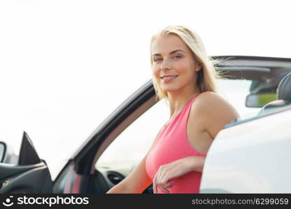 travel, road trip and people concept - happy young woman in convertible car. happy young woman in convertible car