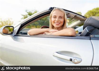 travel, road trip and people concept - happy young woman in convertible car. happy young woman in convertible car