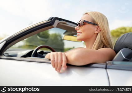 travel, road trip and people concept - happy young woman in convertible car. happy young woman in convertible car