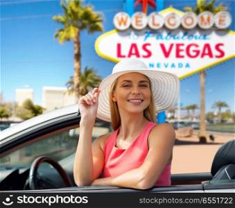 travel, road trip and people concept - happy young woman wearing sun hat in convertible car over welcome to fabulous las vegas sign background. happy young woman in convertible car at las vegas. happy young woman in convertible car at las vegas