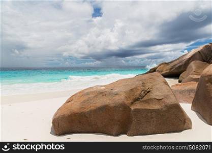 travel, seascape and nature concept - rocks on island beach in indian ocean on seychelles. island beach in indian ocean on seychelles
