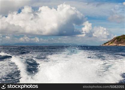 travel, seascape and nature concept - sea or indian ocean and trace on water of boat leaving seychelles. indian ocean and leaving boat trace on water