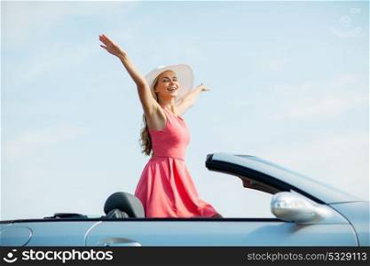 travel, summer holidays, road trip and people concept - happy young woman wearing hat in convertible car enjoying sun. happy young woman in convertible car