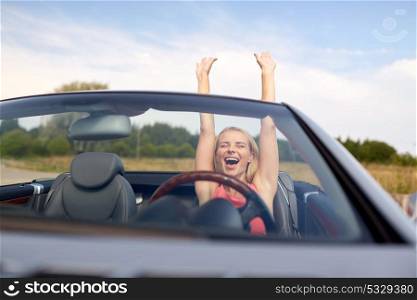 travel, summer holidays, road trip and people concept - happy young woman in convertible car enjoying sun. happy young woman in convertible car