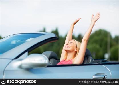 travel, summer holidays, road trip and people concept - happy young woman in convertible car enjoying sun. happy young woman in convertible car