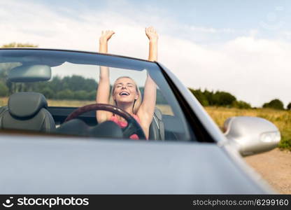 travel, summer holidays, road trip and people concept - happy young woman in convertible car enjoying sun. happy young woman in convertible car