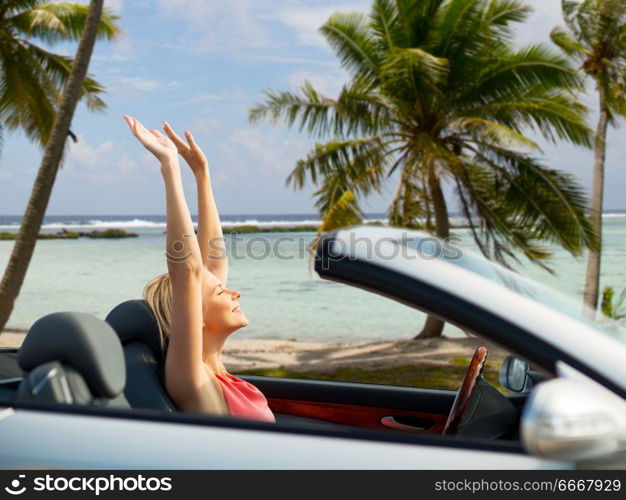 travel, summer holidays, road trip and people concept - happy young woman in convertible car enjoying sun over tropical beach background in french polynesia. happy young woman in convertible car over beach. happy young woman in convertible car over beach