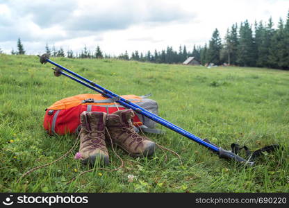 travel. the tourist goes on a hike through the mountains - a backpack, boots and Trekking poles