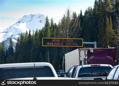 Travel through Roger&rsquo;s Pass in spring. Traffic is stopped while avalanches are triggered with explosives and then cleaned from the road to ensure safe travel. Roger&rsquo;s Pass, British Columbia, Canada.