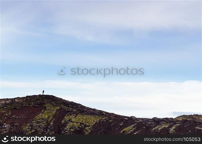 travel to Iceland - blue evening sky over edge of volcanic crater with Kerid lake in september