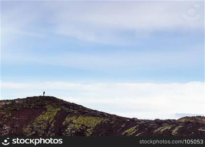 travel to Iceland - blue evening sky over edge of volcanic crater with Kerid lake in september
