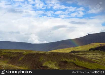 travel to Iceland - rainbow over mountains in Hveragerdi Hot Spring River Trail area in september
