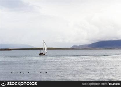 travel to Iceland - view of yacht in Atlantic ocean from promenade Sculpture and Shore Walk in Reykjavik city in september
