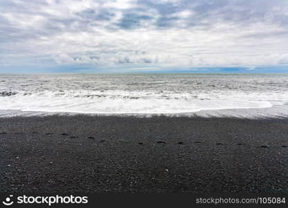 travel to Iceland - waves on Reynisfjara black Beach in Iceland, near Vik I Myrdal village on Atlantic South Coast in Katla Geopark in september