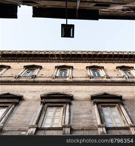 travel to Italy - bottom view of facades of old palaces on narrow street ( Via dei Farnesi) in Rome city